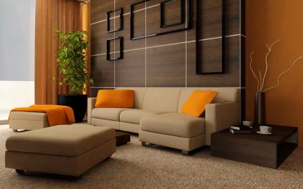 HD PC desktop wallpaper of a modern man-made room featuring a beige sectional sofa with orange cushions, a matching ottoman, and minimalist wall decor.