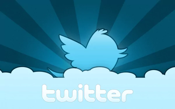 HD PC desktop wallpaper featuring the Twitter logo with a blue bird rising from cloud shapes against a radiant blue background, highlighting technology and social media.