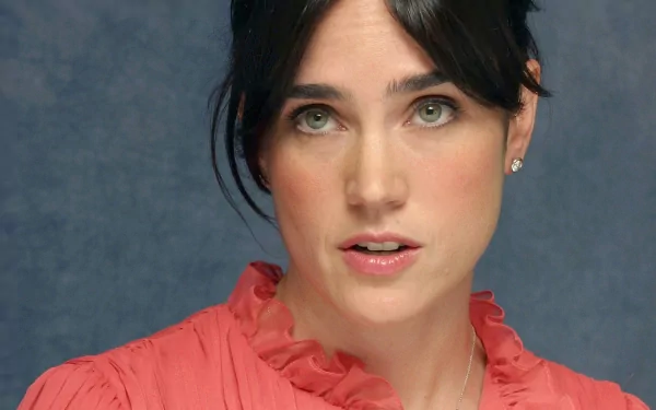 HD PC desktop wallpaper featuring a close-up portrait of actress Jennifer Connelly against a muted blue background.