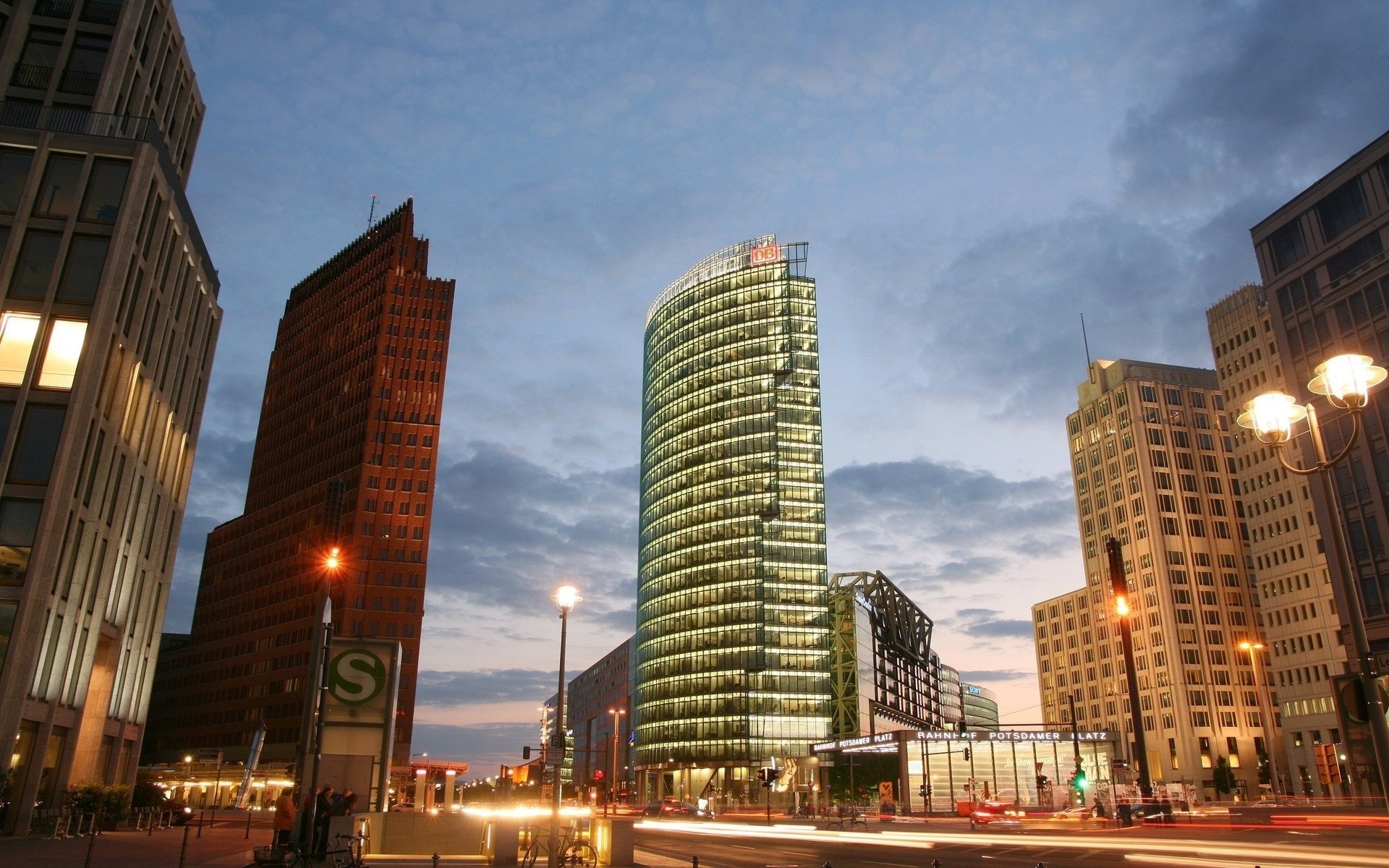 HD desktop wallpaper of Berlin’s modern cityscape at dusk, featuring illuminated man-made skyscrapers in Germany against a deepening evening sky.