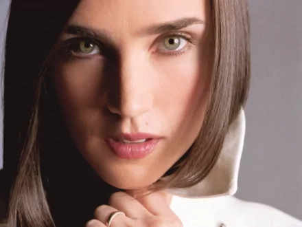 A captivating HD desktop wallpaper featuring actress Jennifer Connelly, showcasing her striking green eyes and elegant pose against a soft background.