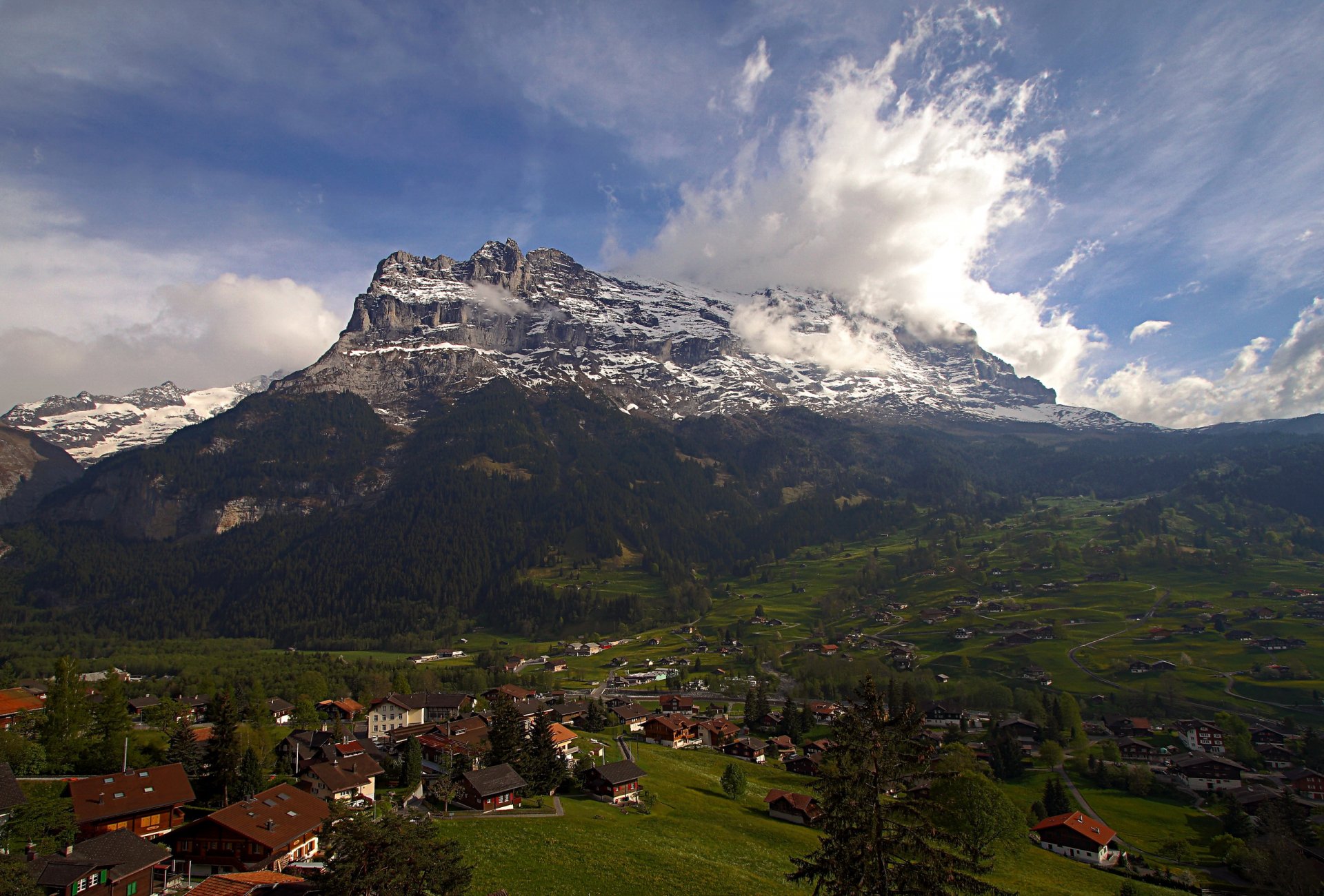 Scenic Mountain Town Under Cloudy Sky - HD Wallpaper