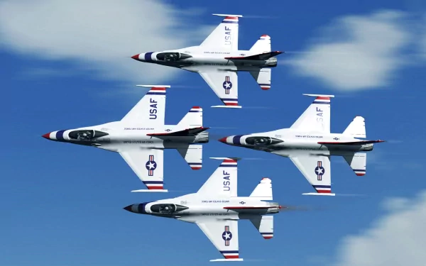 HD desktop wallpaper featuring four military jets in formation at an air show, soaring through a partly cloudy sky.