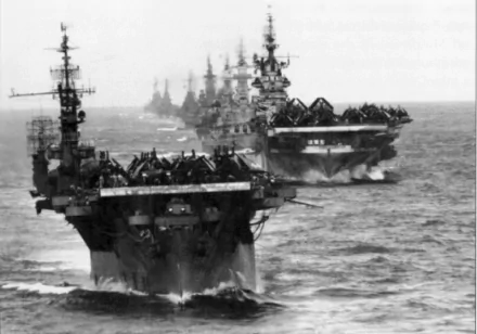 A striking HD wallpaper showcasing military aircraft carriers in formation at sea, highlighting the power and presence of naval forces amidst the ocean waves.