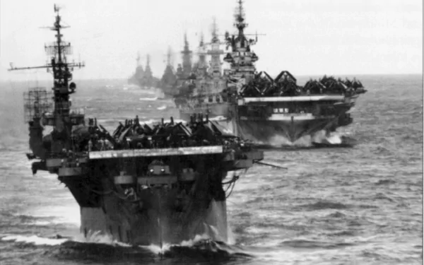A striking HD wallpaper showcasing military aircraft carriers in formation at sea, highlighting the power and presence of naval forces amidst the ocean waves.