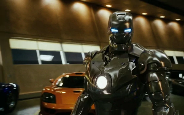 HD desktop wallpaper featuring Tony Stark as Iron Man, with glowing blue eyes and chest reactor, standing in front of an orange sports car inside a dimly lit garage.