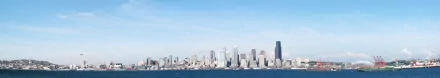 HD desktop wallpaper showcasing the man-made skyline of Seattle against a clear blue sky and waterfront.