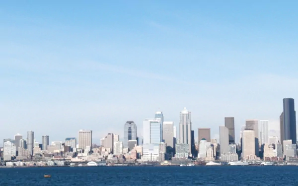 HD desktop wallpaper showcasing the man-made skyline of Seattle against a clear blue sky and waterfront.