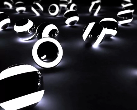 An abstract HD desktop wallpaper featuring a scattered array of shiny black and white balls, creating a captivating and modern aesthetic.