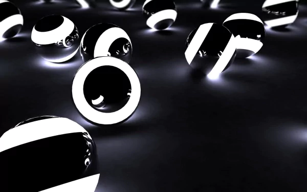 An abstract HD desktop wallpaper featuring a scattered array of shiny black and white balls, creating a captivating and modern aesthetic.