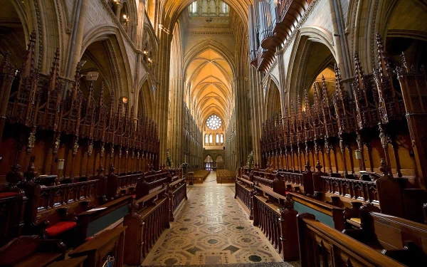 Interior view of Truro Cathedral showcasing its intricate wooden choir stalls and grand arches, captured in high definition for a PC desktop wallpaper.