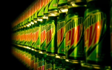 HD desktop wallpaper featuring a vibrant row of Mountain Dew cans, creating a striking visual with reflections and depth in a man-made display.