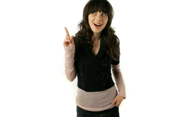 HD wallpaper featuring Zooey Deschanel, smiling and pointing playfully. A vibrant backdrop highlights her charming personality and style.