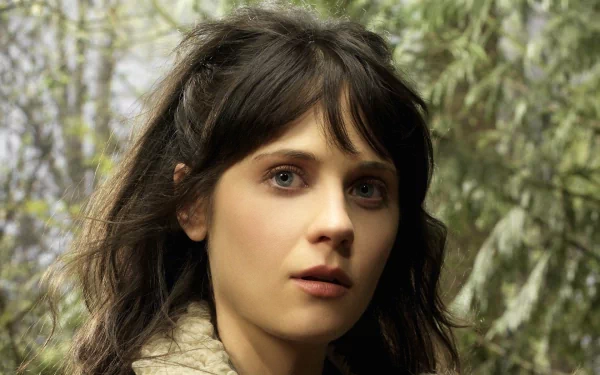 A captivating HD wallpaper featuring Zooey Deschanel as she appears in the TV show Tin Man, set against a lush, enchanting background.