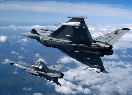 HD desktop wallpaper featuring two military Eurofighter Typhoons in flight against a backdrop of clouds and blue sky.