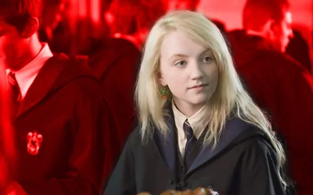 HD desktop wallpaper of Evanna Lynch as Luna Lovegood in the Harry Potter movie, featuring a vibrant red background with other Hogwarts students.