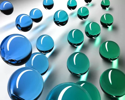An abstract composition featuring a series of glossy spheres in shades of blue and green, creating a dynamic visual effect. This HD image serves as an engaging desktop wallpaper and background.