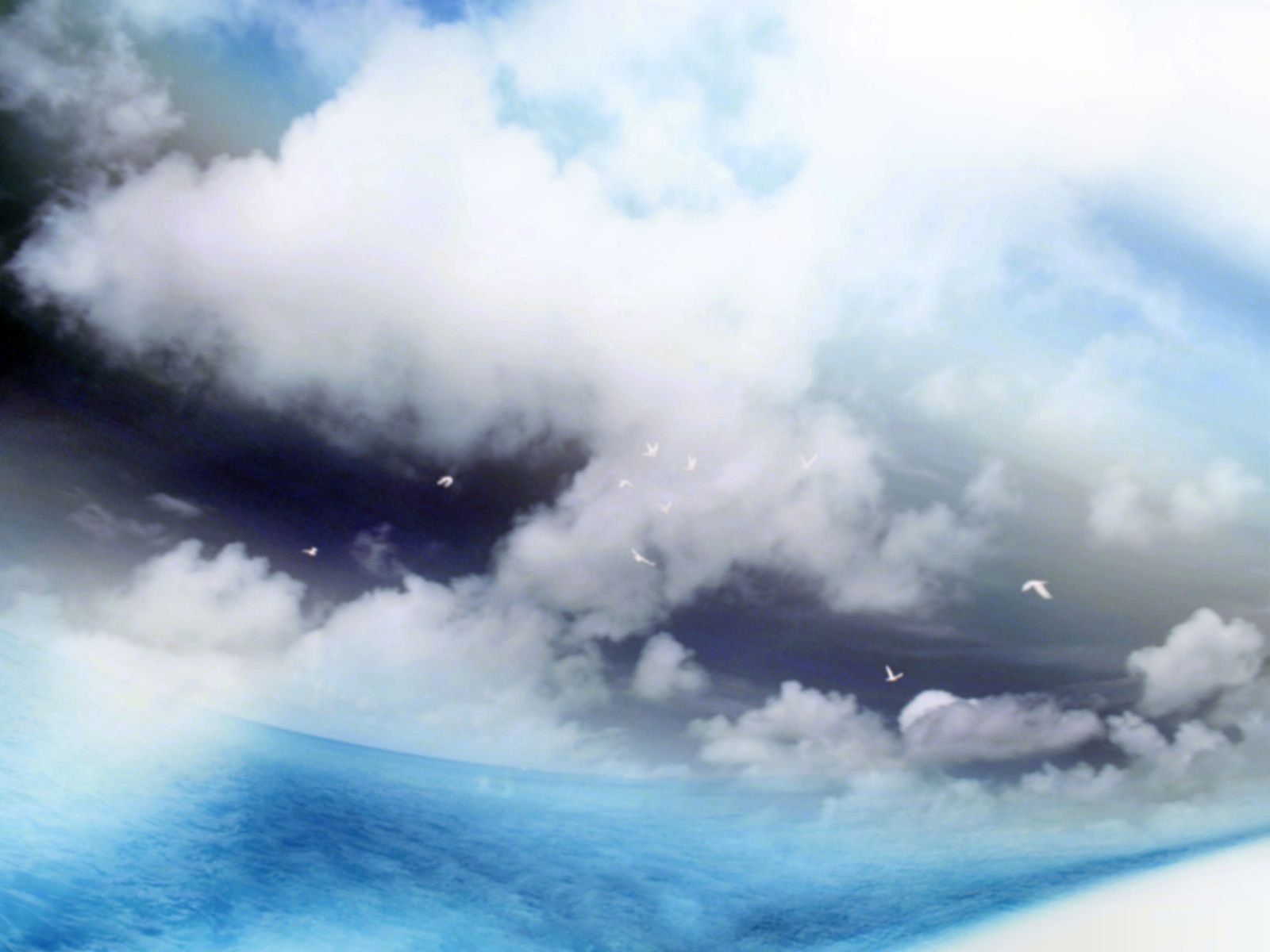 A serene depiction of nature, showcasing soft clouds against a vibrant blue sky, creating a calming PC desktop wallpaper and background.