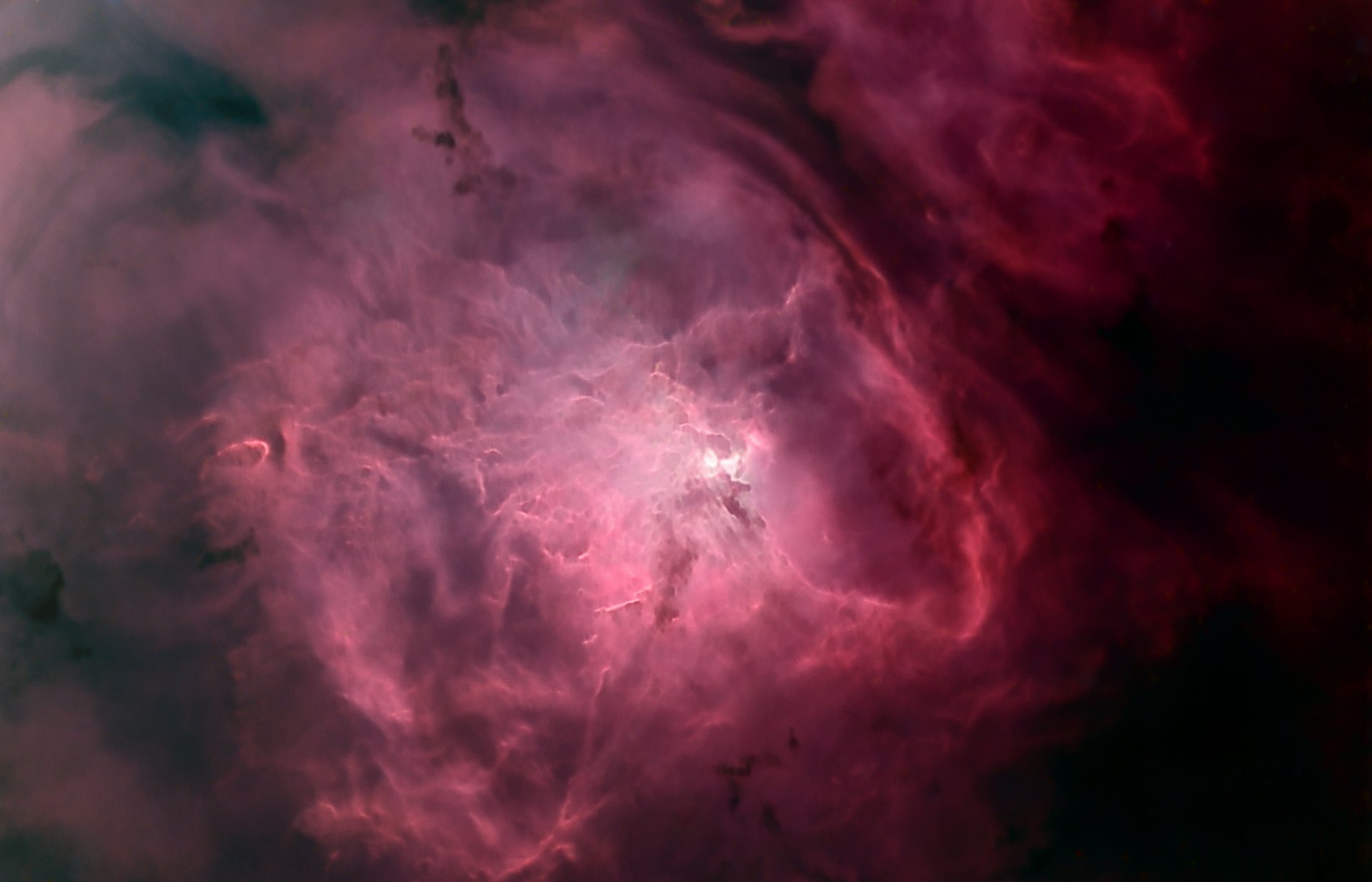 A stunning HD desktop wallpaper featuring a vibrant nebula, showcasing swirling pink and purple hues, set against a dark cosmic background. A captivating sci-fi visual experience.
