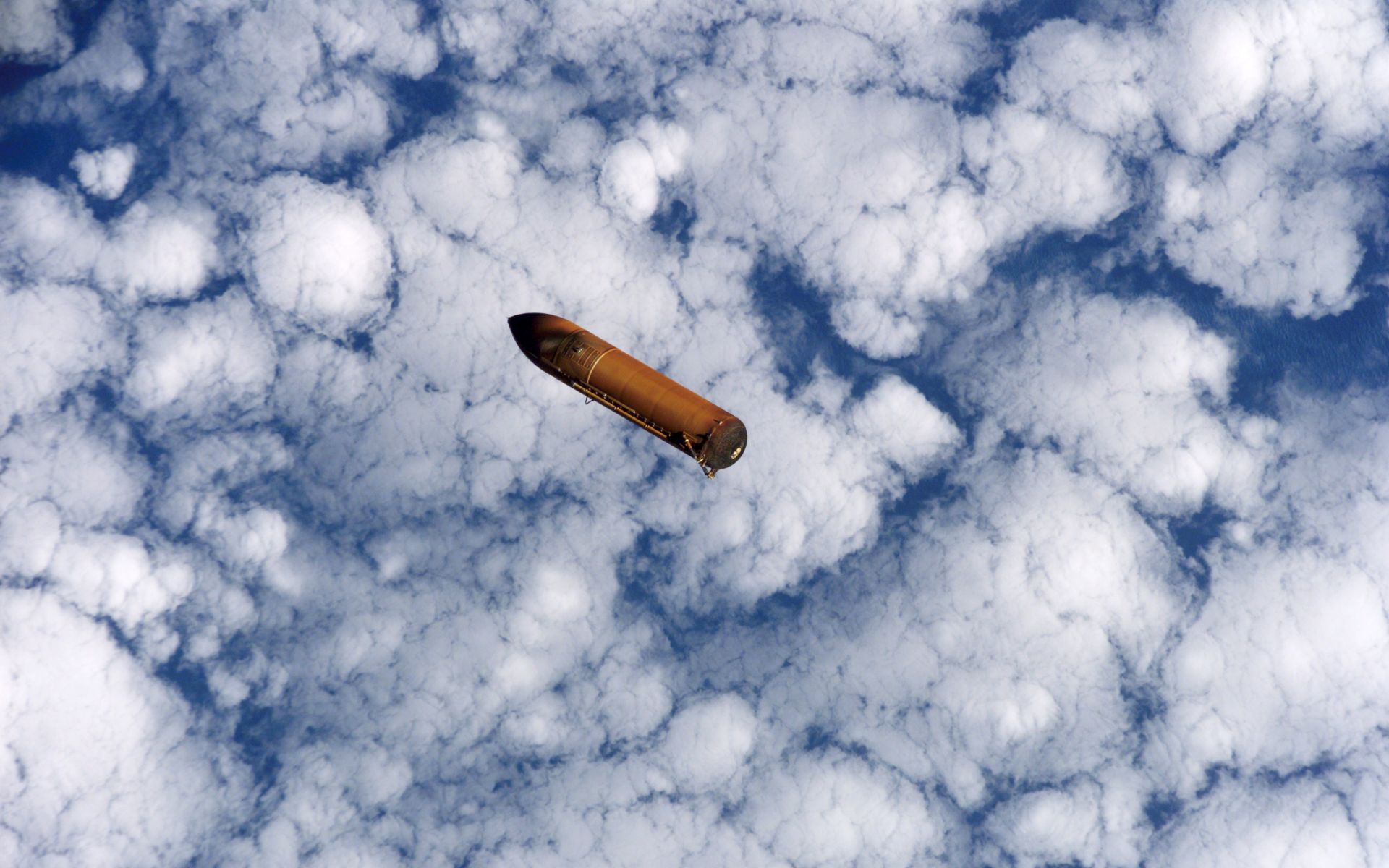Falling external fuel tank against the sky