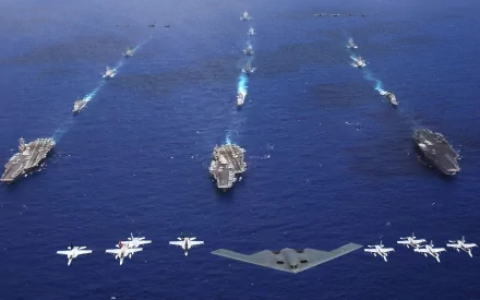 HD desktop wallpaper featuring a military formation with aircraft carriers and planes over a vast ocean.