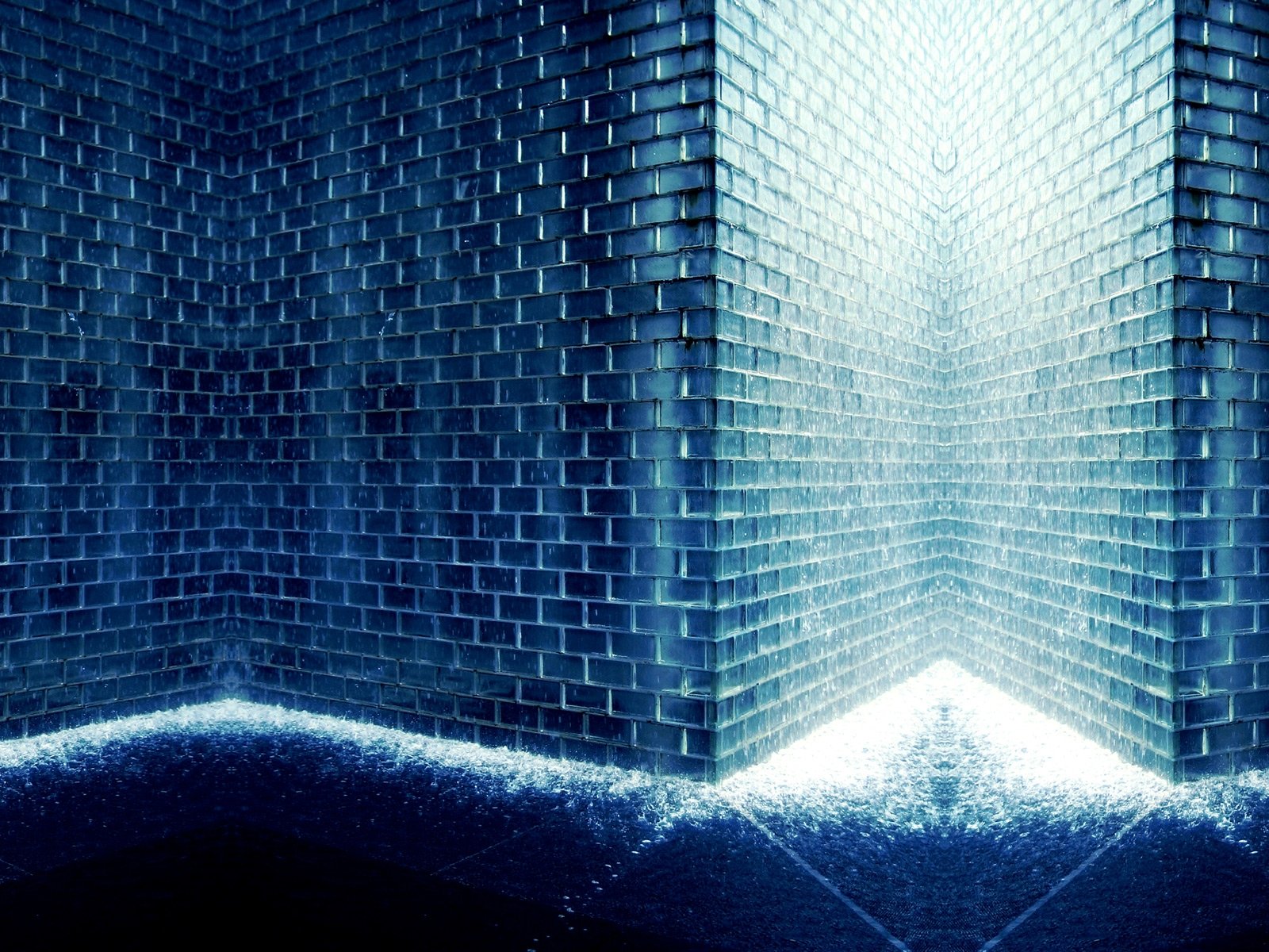 A close-up of an artistic wall featuring intricate blue tiles, creating a dramatic corner effect. This high-definition image serves as a striking desktop wallpaper and background.