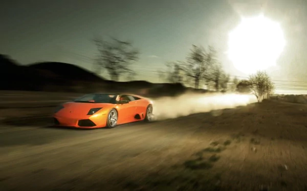 HD PC desktop wallpaper featuring an orange Lamborghini Murcielago speeding on a dusty road with a bright sun and blurred trees in the background.