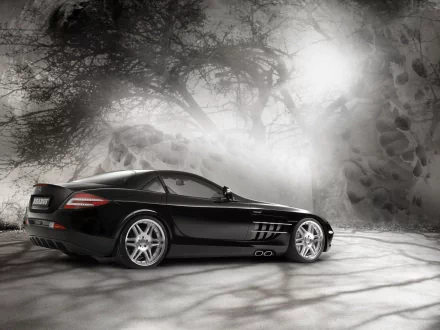 HD wallpaper featuring a sleek black Mercedes-Benz SLR McLaren against a misty, atmospheric backdrop with trees and rocks.