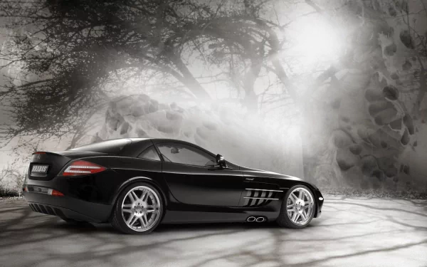 HD wallpaper featuring a sleek black Mercedes-Benz SLR McLaren against a misty, atmospheric backdrop with trees and rocks.