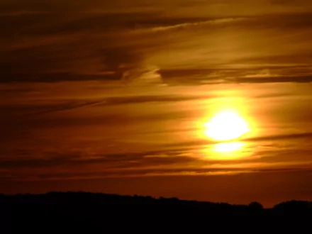 A breathtaking sunset casts a warm golden glow over the horizon, showcasing nature's beauty. This high-definition image serves as a stunning desktop wallpaper and background.