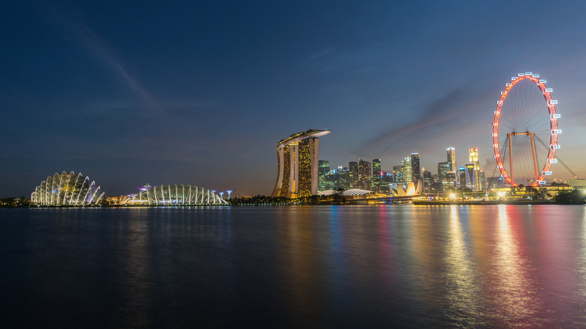 Night view of Singapore’s Marina Bay Sands and city skyline, illuminated against a dark sky, captured in stunning 4K Ultra HD for a PC desktop wallpaper background.
