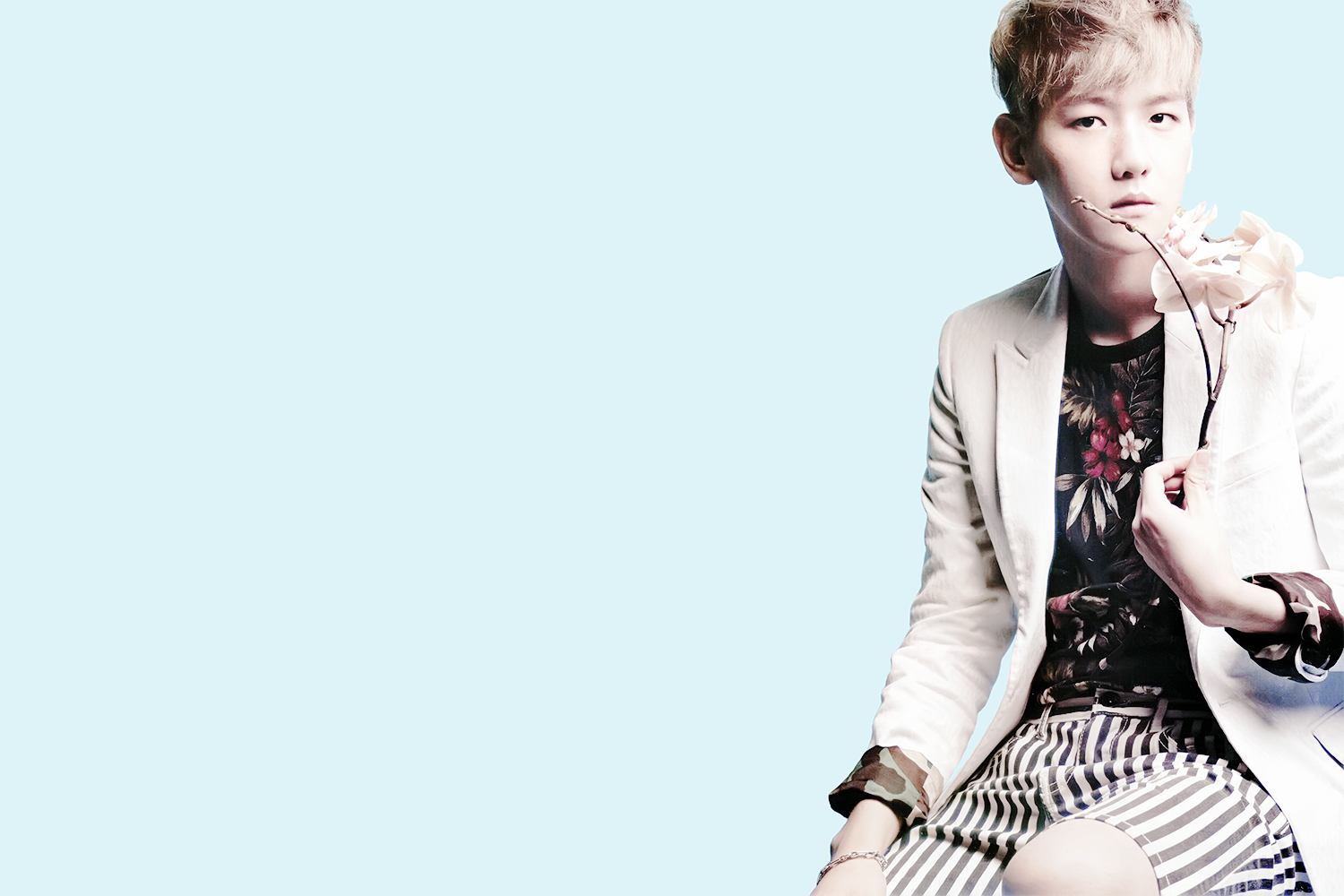 HD PC desktop wallpaper featuring a member of EXO holding a flower against a light blue background, blending music and stylish visuals.