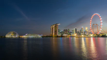 Night view of Singapore’s Marina Bay Sands and city skyline, illuminated against a dark sky, captured in stunning 4K Ultra HD for a PC desktop wallpaper background.
