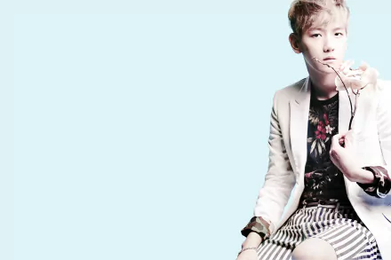 HD PC desktop wallpaper featuring a member of EXO holding a flower against a light blue background, blending music and stylish visuals.