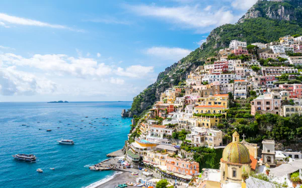 HD desktop wallpaper showcasing a vibrant man-made seascape of Capri, with colorful cliffside buildings overlooking the clear blue sea under a bright sky.