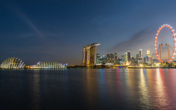 Night view of Singapore’s Marina Bay Sands and city skyline, illuminated against a dark sky, captured in stunning 4K Ultra HD for a PC desktop wallpaper background.