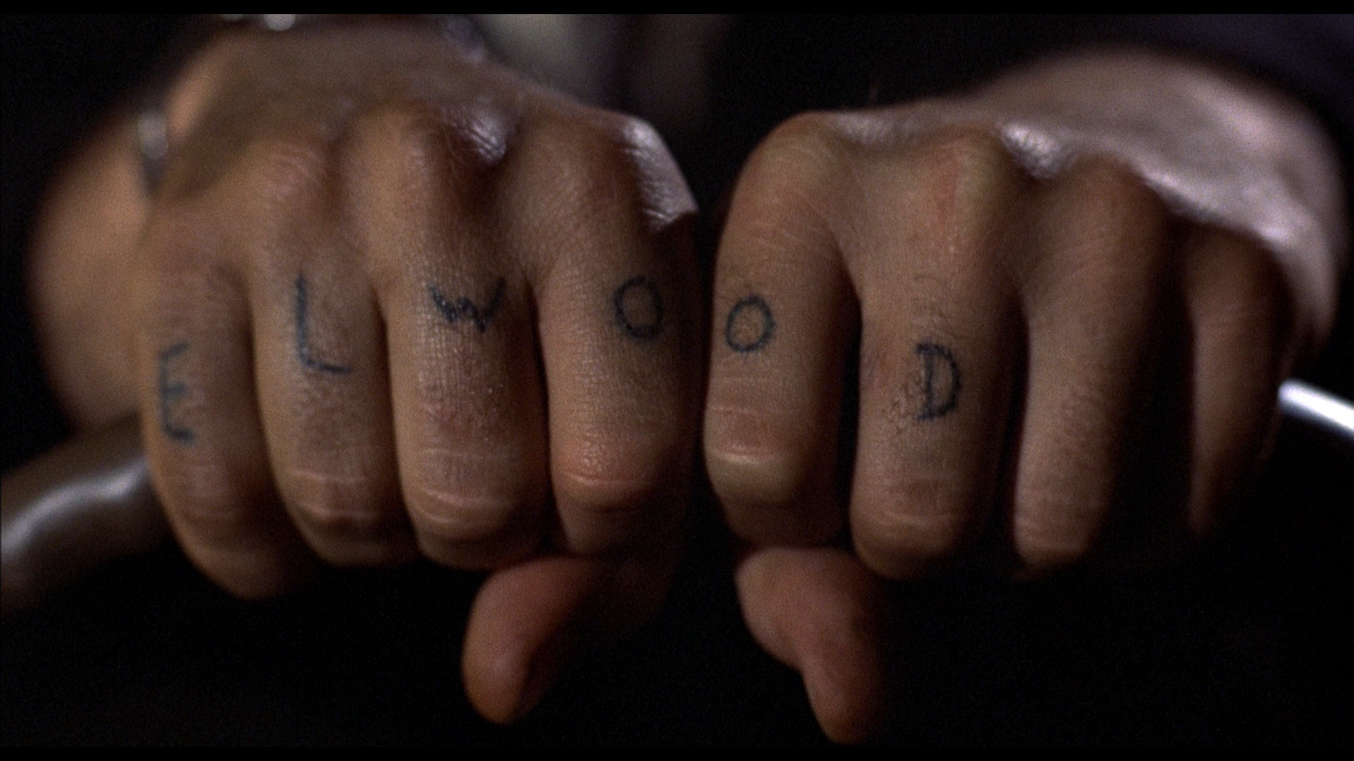 Close-up of tattooed knuckles spelling ELWOOD from the movie The Blues Brothers, shown as an HD PC desktop wallpaper and background.