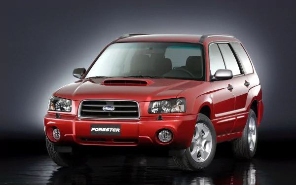 Red Subaru Forester SUV displayed on a glossy black surface with a subtle dark gradient background, featured as an HD PC desktop wallpaper and background.