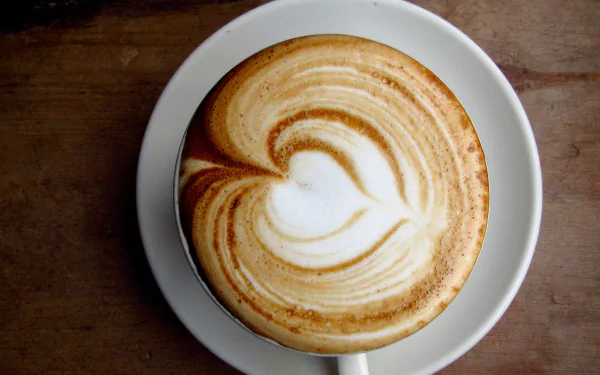 HD desktop wallpaper featuring a cappuccino with heart-shaped latte art on a saucer.