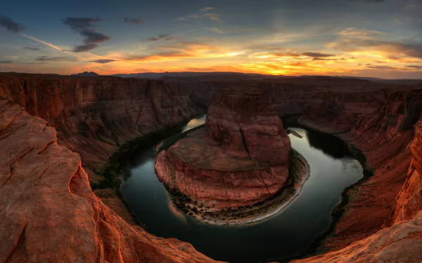 HD PC desktop wallpaper of Horseshoe Bend canyon at sunset, the Colorado River curving around a red sandstone meander beneath a dramatic sky — nature background.
