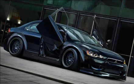 A sleek Mitsubishi Lancer Evolution in black, showcasing its unique doors and sporty design, set against a modern urban backdrop. This HD image serves as a striking PC desktop wallpaper.