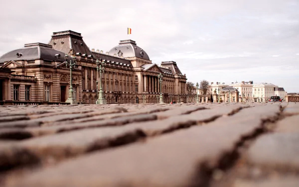 HD desktop wallpaper showcasing the Royal Palace of Brussels, a grand man-made architectural landmark under a cloudy sky.