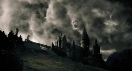 HD desktop wallpaper featuring Hogwarts Castle under a dark, stormy sky, inspired by the Harry Potter movie series.