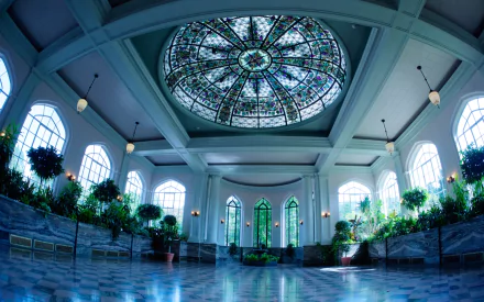 Interior view of Casa Loma featuring a stained glass dome ceiling, arched windows, and indoor greenery, presented as an HD PC desktop wallpaper.