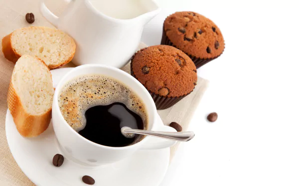 8K Ultra HD PC desktop wallpaper showing a coffee cup with spoon, milk jug, scattered beans, sliced baguette and chocolate muffins — food, coffee.