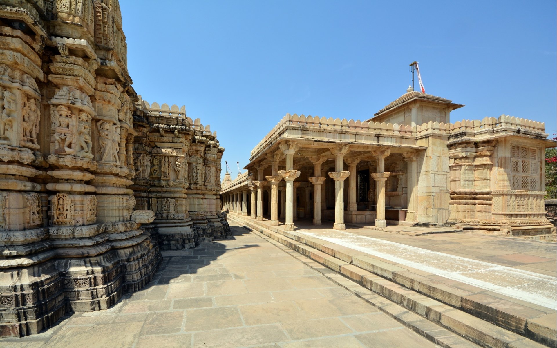 HD PC desktop wallpaper showcasing the intricate man-made architecture of Chittorgarh, featuring detailed stone carvings and a clear blue sky.