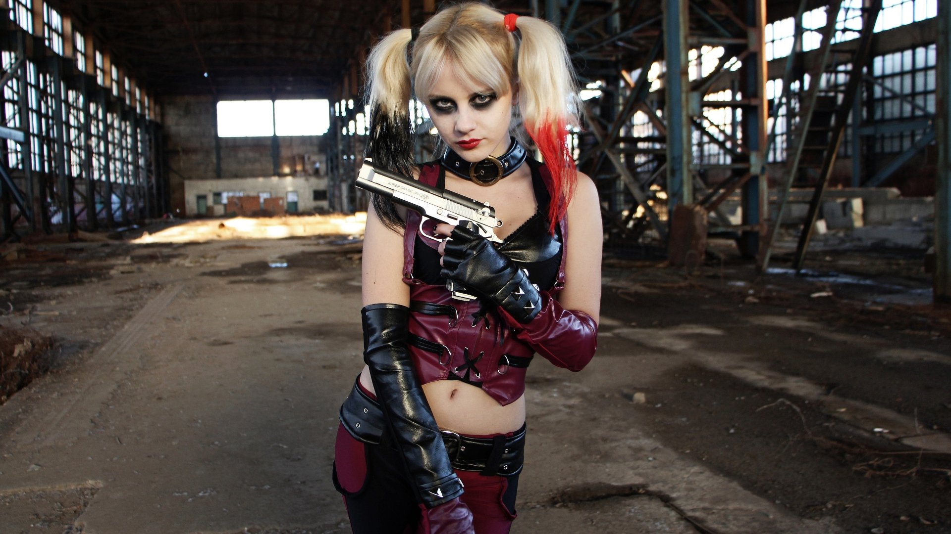 4K Ultra HD wallpaper of a woman in detailed cosplay holding a gun, set in an industrial warehouse environment.