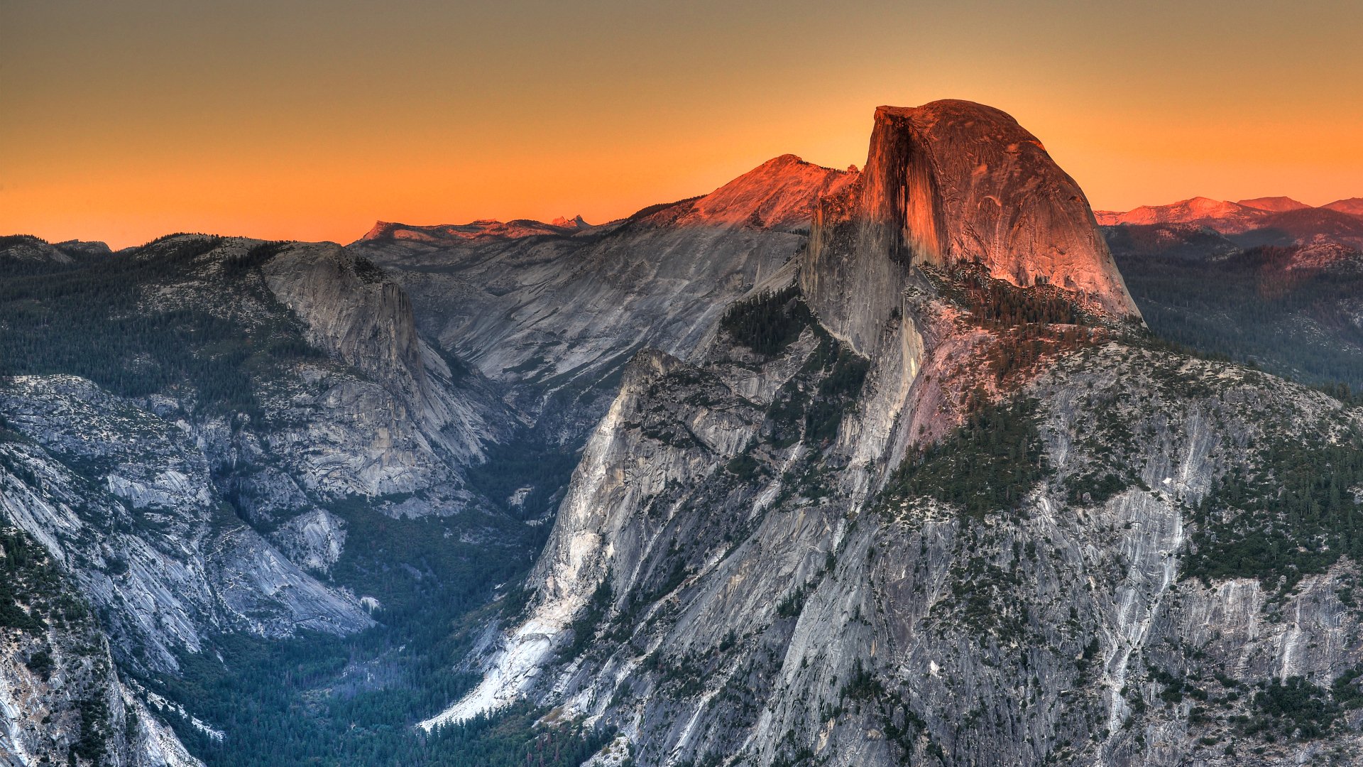 4K Ultra HD PC desktop wallpaper and background: nature landscape of a granite dome glowing orange at sunset above a sweeping valley and forest.