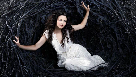 Snow White, portrayed by Ginnifer Goodwin in Once Upon A Time, emerges from a dark, twisted nest, showcasing a captivating blend of fairy tale and drama.