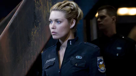 HD desktop wallpaper featuring Tamara Johansen (Alaina Huffman) from the TV show Stargate Universe, dressed in a dark uniform with a serious expression.